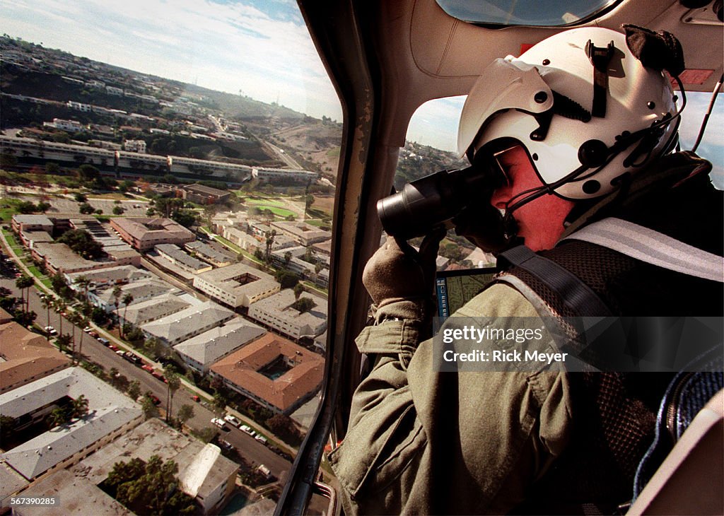 020874.ME.1207.helicop3.rm Photo shows LAPD Tactical Flight Officer Matt Jaroscak as they orbit over