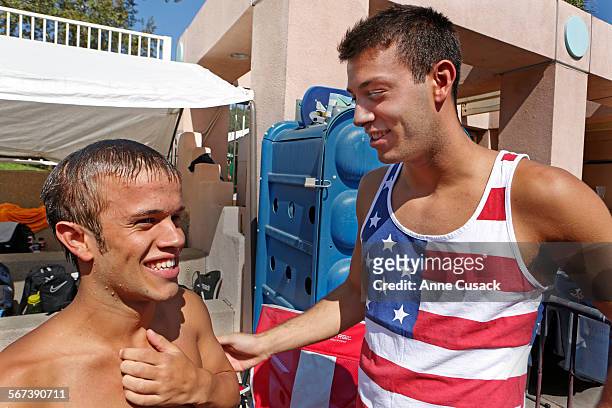 Nick McCrory right, congratulates his brother Lucas McCrory left, who has dwarfism, after he finished the 400-meter freestyle during the 2014 Pan...
