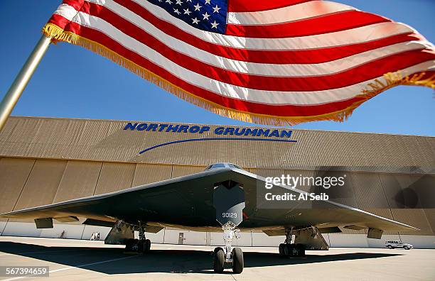 The US flag flies near the U.S. Air Force's B-2 Spirit Stealth bomber "Spirit of Georgia" at the Northrop Grumman Corp. Facility at U.S. Air Force...