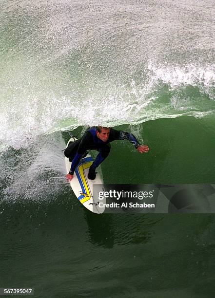 Bigsurf.tube.ryan.1201.ASHUNTINGTON BEACHSurfer Ryan Turner of Huntington Beach peers out of a tube ride on the south side of the Huntington...