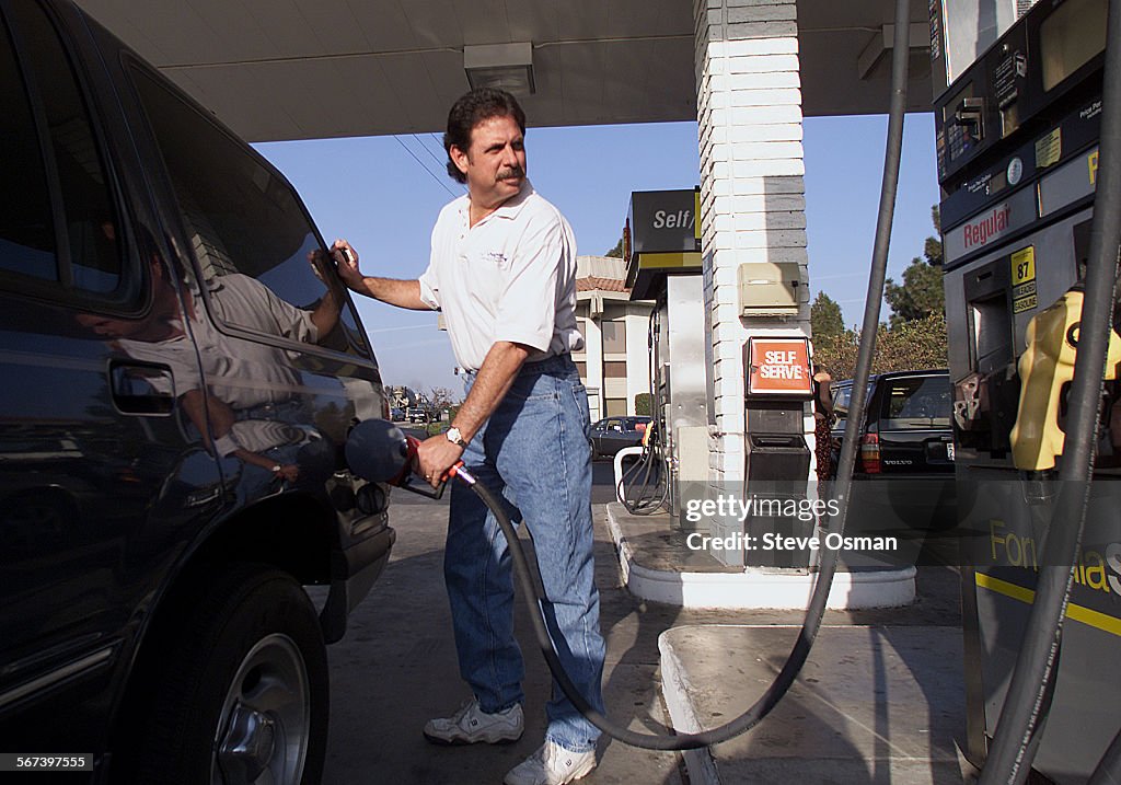 Mario Curci of Oxnard, gases up his SUV at the Shell station on Vineyard Ave. and the 101 freeway in