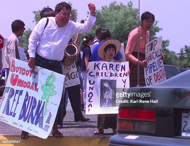 Burma.protesters1.KRH.6/2/97."Free Burma" activists Maung Khin , his daughter Stephanie Shwe and wife Taw Myo Shwe are among those protesting...