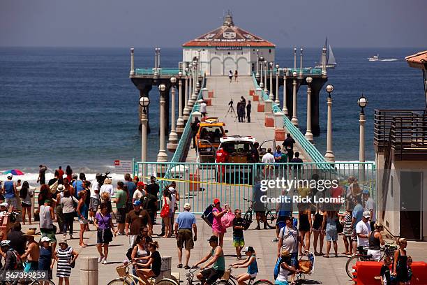 The Manhattan Beach pier was closed off on Saturday morning after a shark attack occured in the waters nearby. The waters were also closed to...