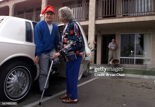 Marcia Flannery arrives with her son Page Dye left, who is develomentally disabled, at their Costa Mesa hotel room. At right is her husband Mike...