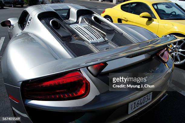 Exhaust gases are expelled through dual top-mounted ports. The 918 Spyder is Porsche's high-performance hybrid sports car boasting 887 horsepower and...