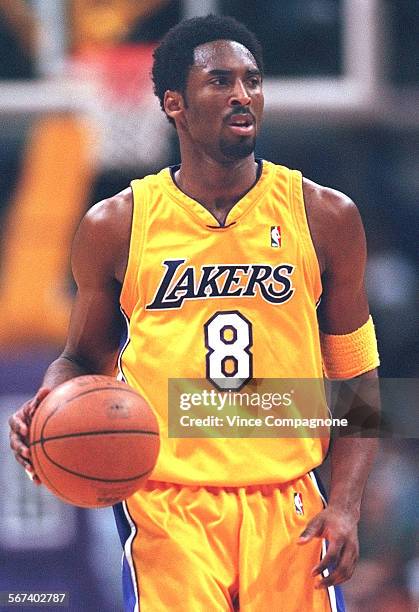 Lakers.33.VC Laker guard Kobe Bryant brings the ball up court during preseason game against the Seattle Supersonics at Staples Center on Oct.20, 2000.