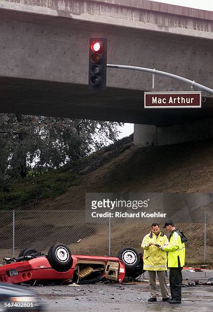Corvette.CHP officer and Irvine police officer investigates accident scene Wednesday approx 7:27 a.m. 2/26/03 on MacArthur Blvd at Fairchild Road....