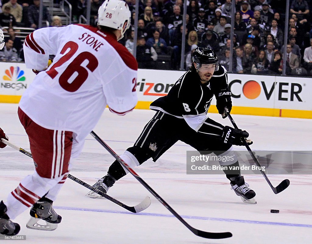LOS ANGELES, CA - APRIL 2, 2014:  Los Angeles Kings Drew Doughty, no. 8 right, looks to pass past Ph