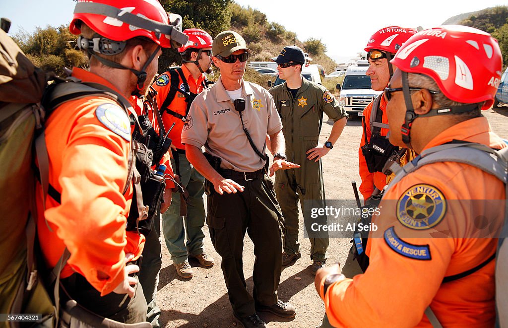 FILLMORE, CA JUNE 17, 2014 -- Ventura County Sheriff's Deputy Chris Johnston, center, holds a pre-