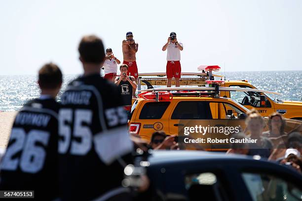 Lifeguards stop to catch a glimpse of the NHL champion LA Kings parade with the Stanley Cup from Redondo to Hermosa to Manhattan Beach.