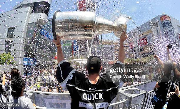Kings goalie Jonathan Quick holds the Stanley Cup at the L.A. Live in Downtown Los Angeles during the championship parade Monday.