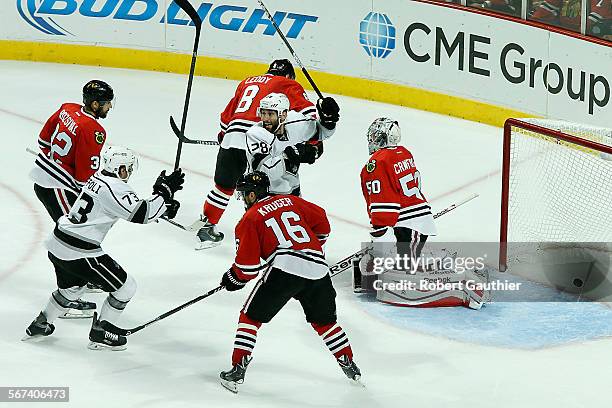 Kings teammates Tyler Toffoli, left, and Jarret Stoll begin the celebration as an Alec Martinez shot finds the net to beat the Blackhawks 5-4 in...