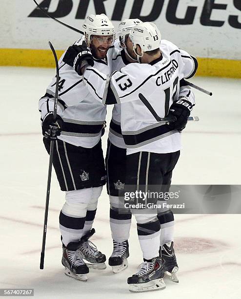 Los Angeles Kings center Mike Richards ,middle, celebrates his first period goal with with Los Angeles Kings left wing Dwight King and Los Angeles...