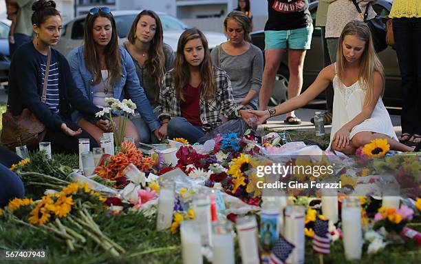 Friends hold hands to pray and remember shooting victims Veronica Weiss of Westlake and Katie Cooper Chino Hills on May 25, 2014 outside the Alpha...