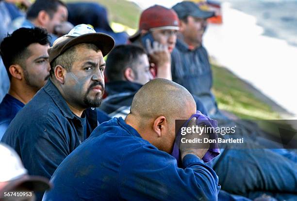 Workers who evacuated Gorilla Polishing Corp. After an explosion and fire inside the business sit outside the rim polishing company at 531 Commercial...