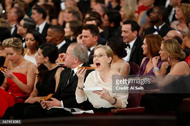 March 2, 2014. Ellen DeGeneres hands out a pizza she ordered from backstage as Meryl Streep eats it at the 86th Annual Academy Awards on Sunday,...