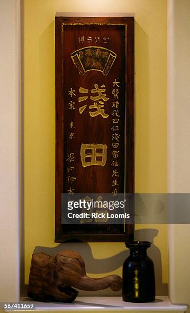 Asiantheme.sign.0313.RLBalboa IslandAn old pharmacy sign from China and a 17th century elephant carving from Japan decorate the foyer area of...