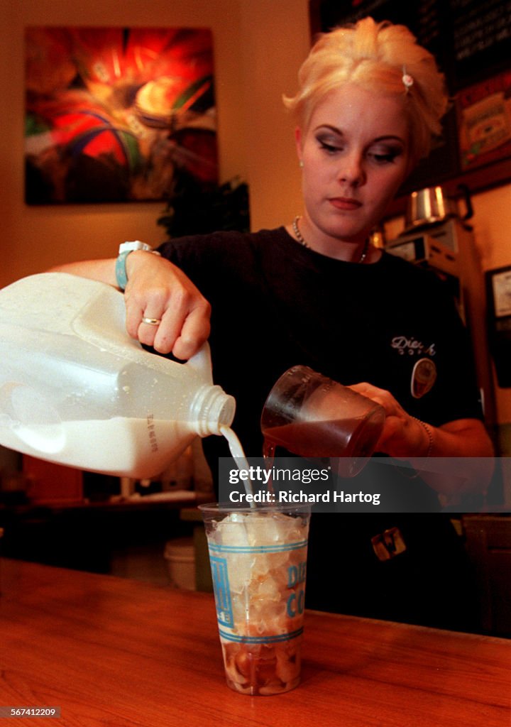 ME.Chai.RH072498Wendy Washinger of Huntington Beach pours milk and chai tea over ice to create a