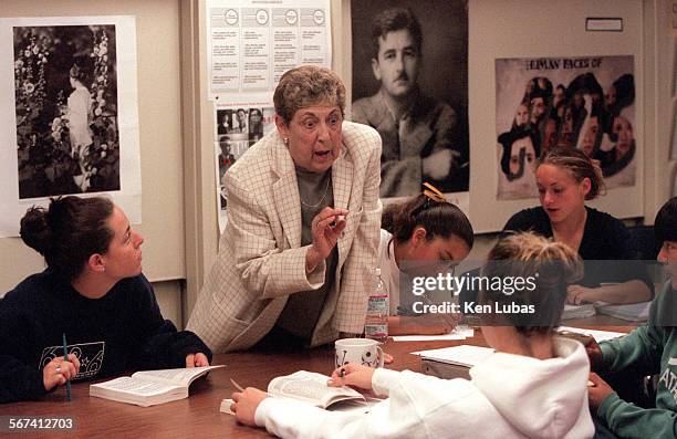 Portrait of William Faulkner peers over shoulder of Dr. Marilyn Whirry, as she works with students in one of her advanced placement English classes...