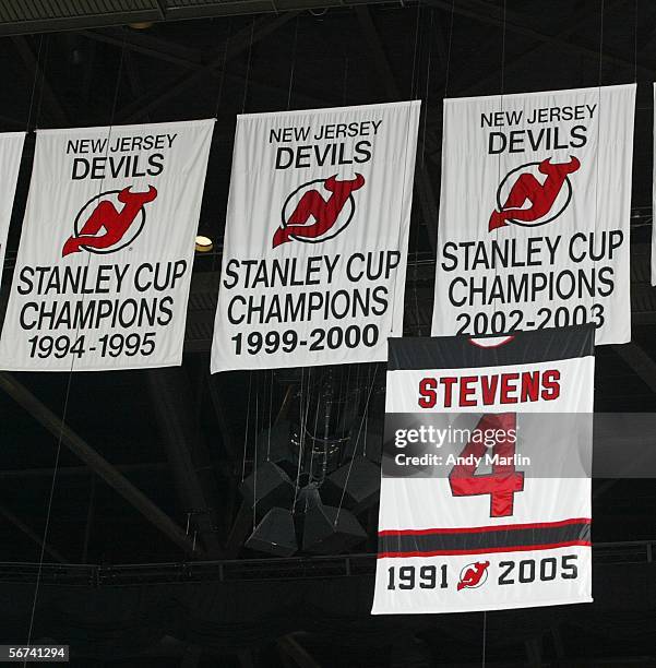 Banner retiring the jersey number of defenseman Scott Stevens of the New Jersey Devils, hangs with three Stanley Cup banners for the Devils before...