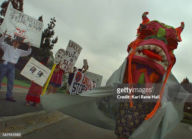 Burma.dragon2.KRH.6/2/97."Free Burma" activists protest Unocal's business ventures with Burma's SLORC regime during a shareholders meeting at Unocal...