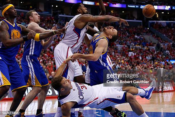 Clippers center DeAndre Jordan shoves Warriors guard Stephen Curry in the face as Blake Griffin falls as Golden State teammates Jermaine Oneal and...