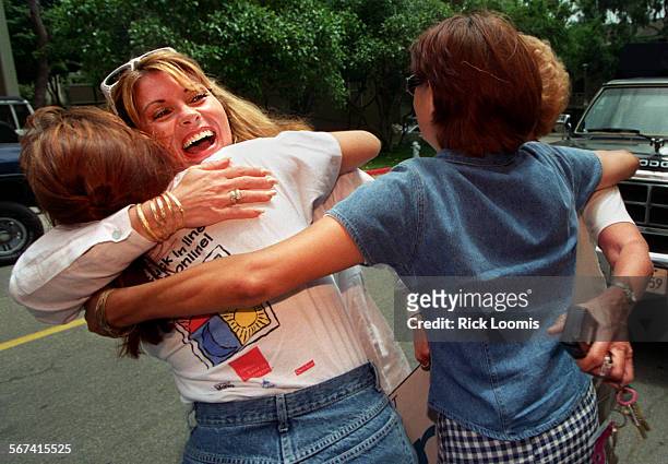 Crummel.hug.0530.RLNewport BeachDarlene Savoji is hugged by neighbors Sandra Bishop, left, Irene Lewis and Lori Martin after they learned of the...