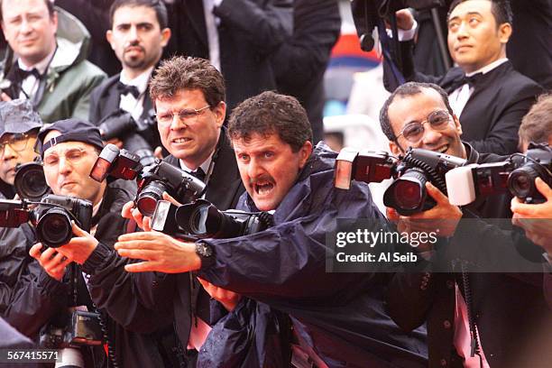 Cannes3.as. CANNES, FRANCE 53rd Festival International Du Film. Rain didn't dampen the spirits of the huddled media as they photograph the arrivals...