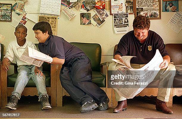Saldana#4.0918.GFPrincipal Matt Saldana hangs out at his Uncle Frank Saladana's barbershop, Lolo's, after school to read the daily paper. His...
