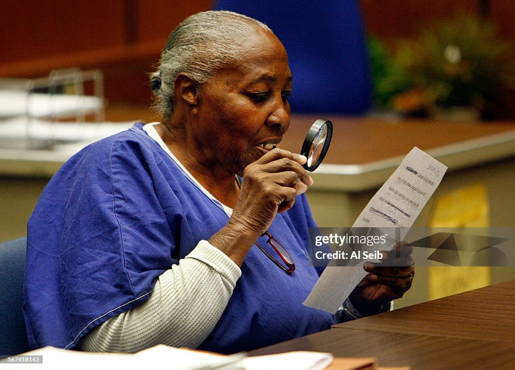 LOS ANGELES, CA - MARCH 24, 2014:   Mary Virginia Jones uses a magnifier to read her no contest plea