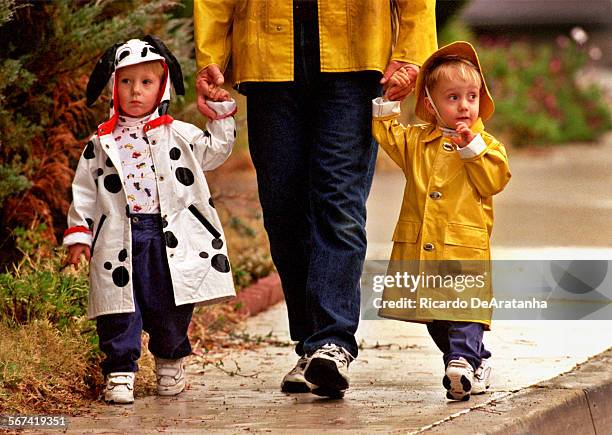 Tuesday, 1/25/00 Andrew La Chapelle left, and twin brother Pat, holding their father's hand while coming back home from day care in Thousand Oaks....