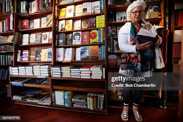 Karyn Noel takes a few moments to read through a copy of "Infinite Jest" by David Foster Wallace at the City Lights Bookstore on MARCH 07, 2014....