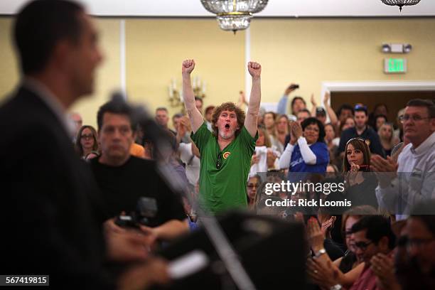 Tim O'Hollearn a prop maker from West Hollywood, Ca., cheers with other Hollywood workers gathered in Burbank at Pickwick Gardens to discuss how to...