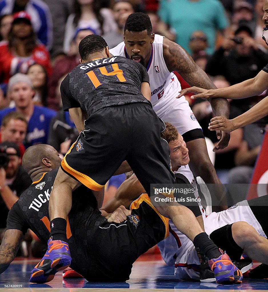 LOS ANGELES, CALIF. - MAR. 10, 2014. Clippers power forward Blake Griffin gets tangled up with Suns 