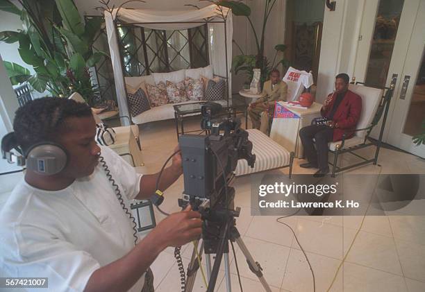 Billy.5.LH.73Billy Walker, right, a local cable talk show host, gets ready to tape an interview with basketball player, Kenny Anderson, at the...