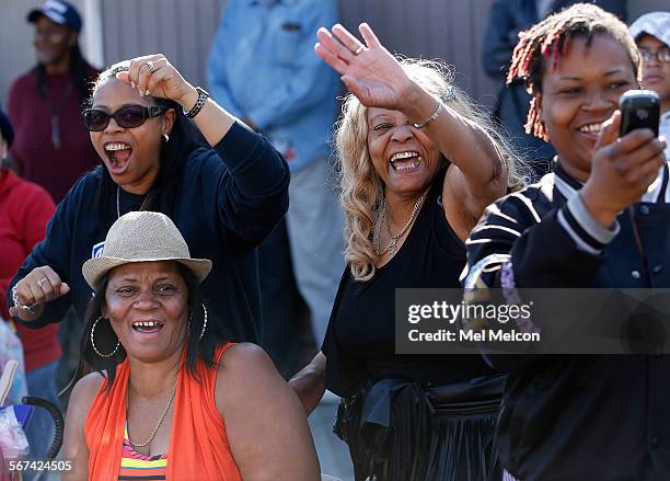 Clockwise from top left-Desiree Rideaux, her mother Pat Arch, friend Laneatra Burrus, and friend Jeanette Tate wave to performers during the 29th...