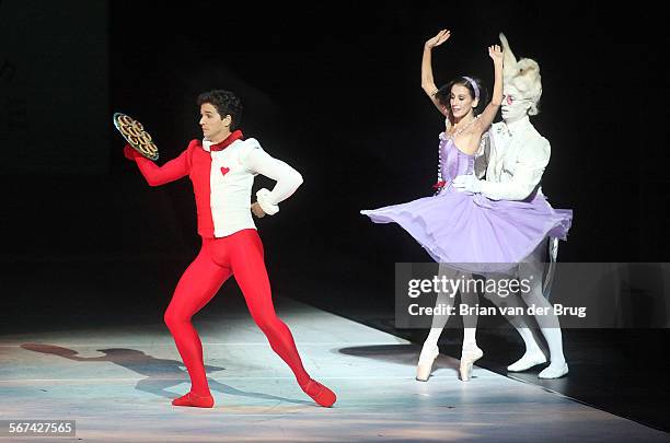 Ballerina Sonia Rodriguez as Alice and White Rabbit Aleksandar Antonijevic, right, with Guillaume Cote as the Knave of Hearts, left, perform in the...
