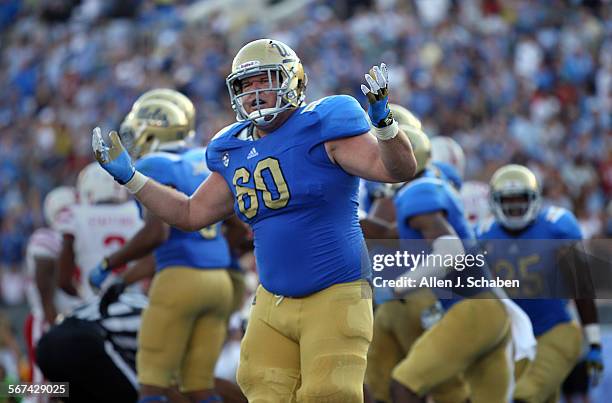 Offensive guard Jeff Baca celebrates Joseph Fauria's touchdown in the second quarter past Nebraska's Daimion Stafford at the Rose Bowl in Pasadena...