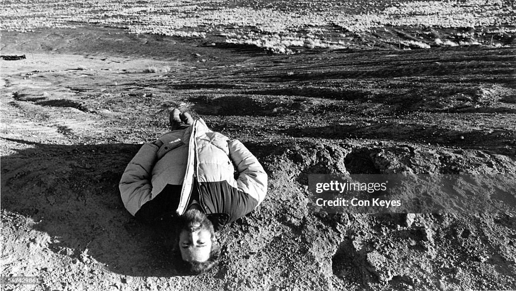 March 13, 1984  Published Caption: James Turrell lies near the center of Roden Crater and looks hea