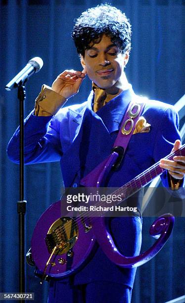 Prince performs "Purple Rain" as the opening act during the 46th Annual Grammy Awards show, at the Staples Center in Los Angeles, Calif., Sunday,...