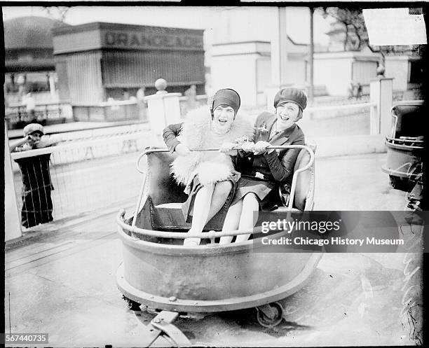 Two women sitting in a car on a ride at the White City amusement park, located at 63rd and South Parkway in the Englewood community area, Chicago,...