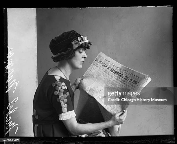 Half-length portrait in profile of Mabel Normand, a silent film actress, sitting and reading a copy of the Chicago Daily News in a room, Chicago,...