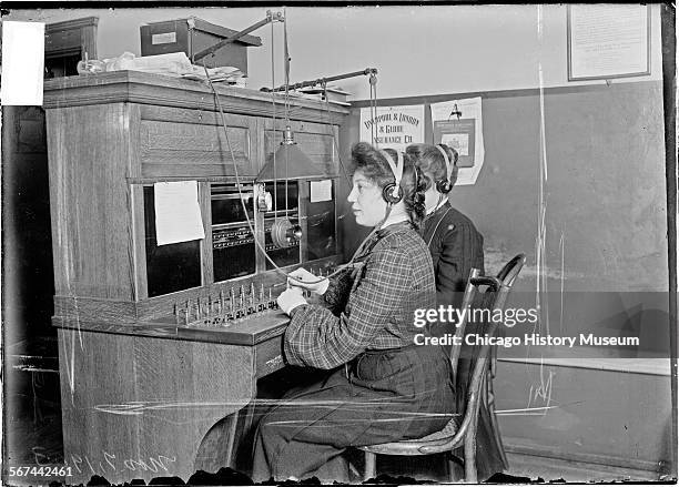 Image of two Chicago Daily News telephone operators sitting at a switchboard, Chicago, Illinois, November 7, 1903.