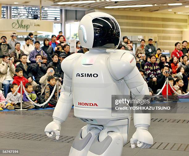 Japanese auto giant Honda Motor's humanoid robot Asimo, which can run at a speed of 6 kph and also in a circular pattern, shows his skill before...