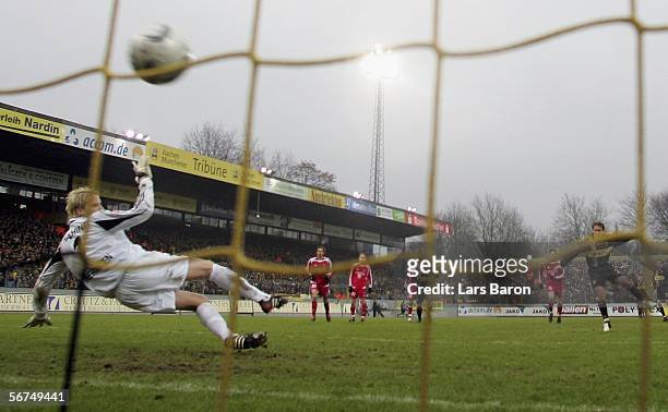 Laurentiu Reghecampf of Aachen scores the first goal from the penalty spot past goalkeeper Phillip Heerwagen of Unterhaching during the Second...