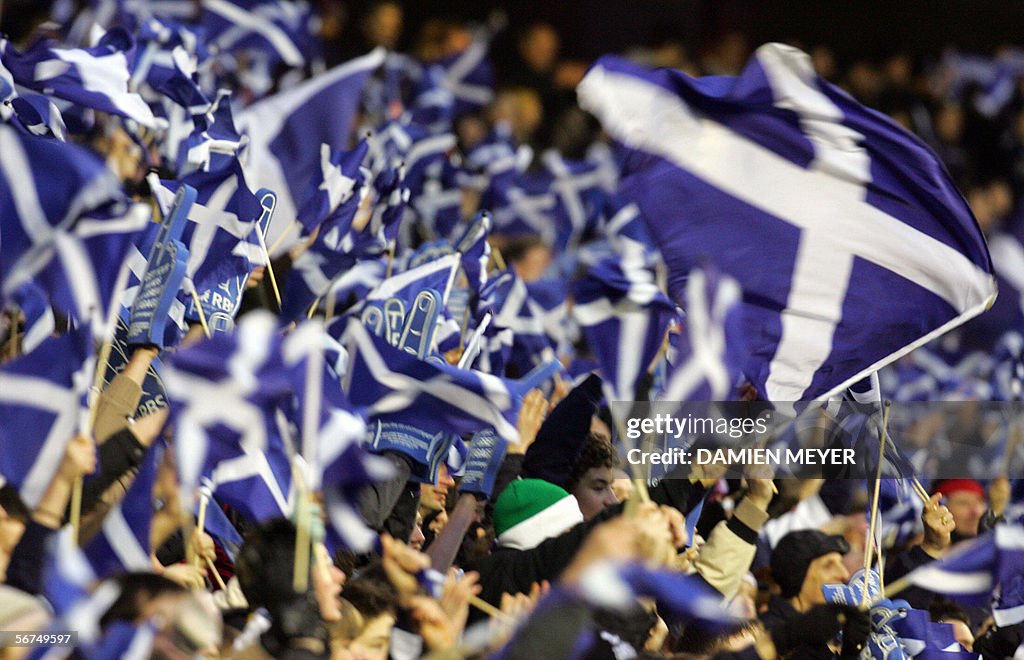 Scotland's fans wave flags after their t