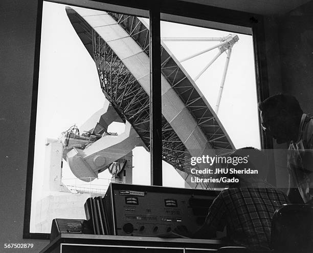 View of a pair of unidentified technicians in the satellite command and telemetry station at Johns Hopkins' Applied Physics Laboratory, 1970. Outside...