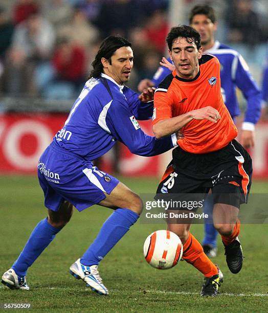 Valentin Pachon of Getafe is tackled by Santiago Carpintero of Alaves during the Primera Liga match between Getafe and Alaves at the Coliseum Alfonso...