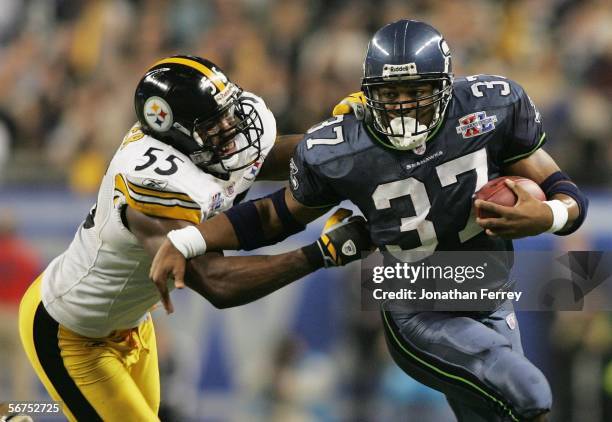 Running back Shaun Alexander of the Seattle Seahawks tries to avoid a tackle by linebacker Joey Porter of the Pittsburgh Steelers in the third...