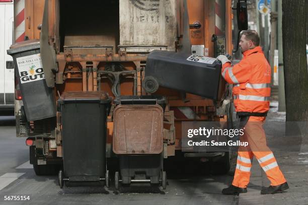 Worker brings garbage cans to a garbage truck February 6 in Berlin, Germany. In the German state of Baden-Wuerttemberg thousands of public sector...